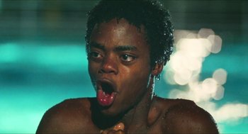 Movie still from “Kids” (1995), directed by Larry Clark – A young man with his tongue hanging out by a pool; Close Up shot, Low angle