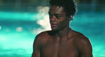 Movie still from “Kids” (1995), directed by Larry Clark – A man with a beard is standing by a pool; Close Up shot, Low angle