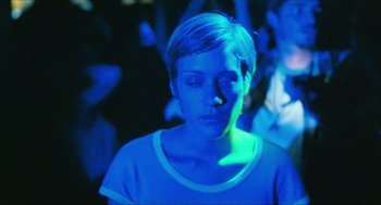 Movie still from “Kids” (1995), directed by Larry Clark – A woman with her eyes closed in a dark room; Close Up shot, High angle