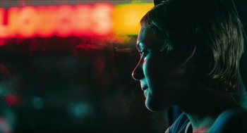 Movie still from “Kids” (1995), directed by Larry Clark – A woman looking out a window at night; Close Up shot, Over the shoulder angle