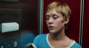 Movie still from “Kids” (1995), directed by Larry Clark – A woman with short blonde hair sitting in a train; Close Up shot, Overhead angle