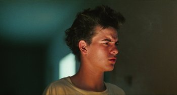 Movie still from “Kids” (1995), directed by Larry Clark – A young man is looking to his left; Close Up shot, Low angle