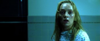 Movie still from “Kill Bill: Vol. 1” (2003), directed by Quentin Tarantino – A woman with long blonde hair stares into the camera; Close Up shot, Low angle