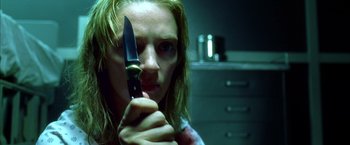 Movie still from “Kill Bill: Vol. 1” (2003), directed by Quentin Tarantino – A woman holding a knife in her hand; Close Up shot, Low angle