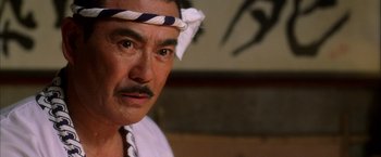 Movie still from “Kill Bill: Vol. 1” (2003), directed by Quentin Tarantino – A person wearing a head band; Close Up shot, Low angle