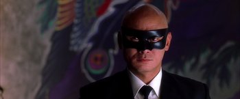 Movie still from “Kill Bill: Vol. 1” (2003), directed by Quentin Tarantino – A man in a suit and tie wearing a black mask; Close Up shot, Low angle