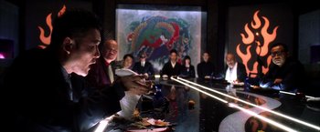 Movie still from “Kill Bill: Vol. 1” (2003), directed by Quentin Tarantino – A group of people sitting around a table with food on top of it; Medium shot, Over the shoulder angle