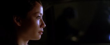 Movie still from “Kill Bill: Vol. 1” (2003), directed by Quentin Tarantino – A woman's face in the dark; Close Up shot, Over the shoulder angle