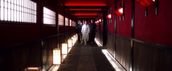 Movie still from “Kill Bill: Vol. 1” (2003), directed by Quentin Tarantino – A group of people walking down a long hallway; Wide shot, Low angle