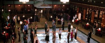 Movie still from “Kill Bill: Vol. 1” (2003), directed by Quentin Tarantino – A group of people standing around in a room; Extreme Wide shot, High angle