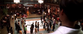 Movie still from “Kill Bill: Vol. 1” (2003), directed by Quentin Tarantino – A group of people standing on a dance floor; Extreme Wide shot, High angle