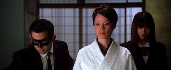 Movie still from “Kill Bill: Vol. 1” (2003), directed by Quentin Tarantino – A woman in a white robe and a man in a black suit; Close Up shot, Over the shoulder angle