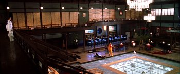 Movie still from “Kill Bill: Vol. 1” (2003), directed by Quentin Tarantino – Two people are laying on the floor of a theater; Extreme Wide shot, High angle