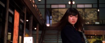 Movie still from “Kill Bill: Vol. 1” (2003), directed by Quentin Tarantino – A woman standing in front of a set of stairs; Close Up shot, Low angle