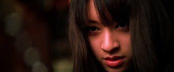 Movie still from “Kill Bill: Vol. 1” (2003), directed by Quentin Tarantino – A woman's face with long dark hair; Close Up shot, Low angle