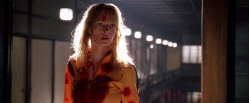 Movie still from “Kill Bill: Vol. 1” (2003), directed by Quentin Tarantino – A woman with blood on her face and chest; Close Up shot, Low angle