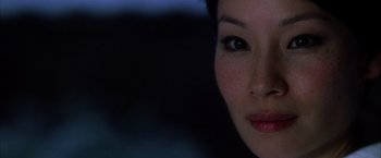 Movie still from “Kill Bill: Vol. 1” (2003), directed by Quentin Tarantino – A woman's face in the dark; Close Up shot, Over the shoulder angle