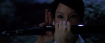 Movie still from “Kill Bill: Vol. 1” (2003), directed by Quentin Tarantino – A person holding a chopstick; Close Up shot, Over the shoulder angle