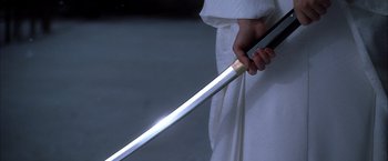 Movie still from “Kill Bill: Vol. 1” (2003), directed by Quentin Tarantino – A person is holding a sword in their hand; Extreme Close Up shot, Low angle