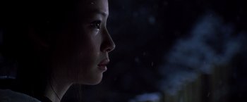 Movie still from “Kill Bill: Vol. 1” (2003), directed by Quentin Tarantino – A woman's face in the dark; Close Up shot, Low angle