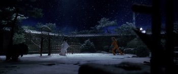 Movie still from “Kill Bill: Vol. 1” (2003), directed by Quentin Tarantino – A couple of people are playing a game in the snow at night; Extreme Wide shot, Low angle
