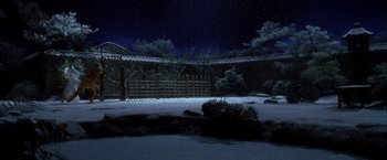 Movie still from “Kill Bill: Vol. 1” (2003), directed by Quentin Tarantino – A night scene of an outdoor area with a fence and trees; Extreme Wide shot, Low angle