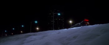 Movie still from “Kill Bill: Vol. 1” (2003), directed by Quentin Tarantino – A view of a city at night from a hill; Extreme Wide shot, Low angle