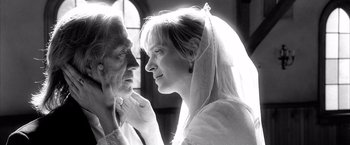 Movie still from “Kill Bill: Vol. 2” (2004), directed by Quentin Tarantino – An older man and a younger woman looking at one another; Close Up shot, Low angle