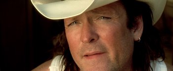 Movie still from “Kill Bill: Vol. 2” (2004), directed by Quentin Tarantino – A person wearing a cowboy hat; Close Up shot, Over the shoulder angle