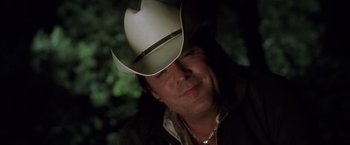 Movie still from “Kill Bill: Vol. 2” (2004), directed by Quentin Tarantino – A person wearing a cowboy hat; Close Up shot, Over the shoulder angle