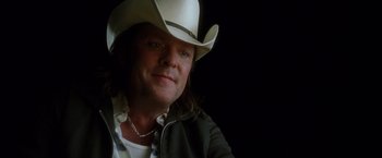 Movie still from “Kill Bill: Vol. 2” (2004), directed by Quentin Tarantino – A person wearing a cowboy hat; Close Up shot, Over the shoulder angle
