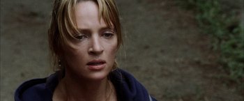 Movie still from “Kill Bill: Vol. 2” (2004), directed by Quentin Tarantino – A person wearing a blue jacket; Close Up shot, Over the shoulder angle