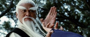 Movie still from “Kill Bill: Vol. 2” (2004), directed by Quentin Tarantino – An old man with long white hair and a long white beard; Close Up shot, Over the shoulder angle