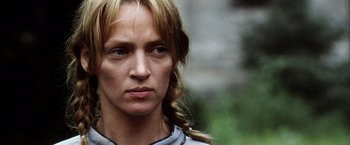 Movie still from “Kill Bill: Vol. 2” (2004), directed by Quentin Tarantino – A person with long blonde hair; Close Up shot, Low angle