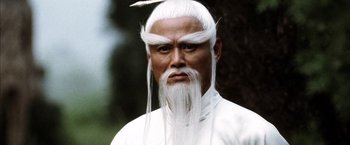 Movie still from “Kill Bill: Vol. 2” (2004), directed by Quentin Tarantino – A man with a long white hair and a long beard; Close Up shot, Low angle