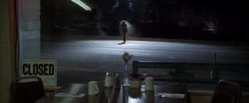 Movie still from “Kill Bill: Vol. 2” (2004), directed by Quentin Tarantino – A person standing in the middle of a street; Wide shot, Over the shoulder angle