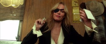 Movie still from “Kill Bill: Vol. 2” (2004), directed by Quentin Tarantino – A woman in a black jacket holding a cell phone to her ear; Close Up shot, Low angle