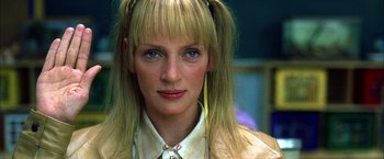 Movie still from “Kill Bill: Vol. 2” (2004), directed by Quentin Tarantino – A person with long blonde hair; Close Up shot, Low angle