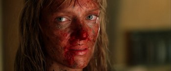 Movie still from “Kill Bill: Vol. 2” (2004), directed by Quentin Tarantino – A person's face covered in blood; Close Up shot, Low angle