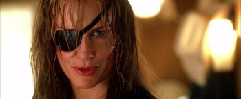 Movie still from “Kill Bill: Vol. 2” (2004), directed by Quentin Tarantino – A person with wet hair wearing a eye patch; Close Up shot, Low angle