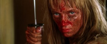 Movie still from “Kill Bill: Vol. 2” (2004), directed by Quentin Tarantino – A person holding a sword; Close Up shot, Low angle
