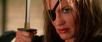 Movie still from “Kill Bill: Vol. 2” (2004), directed by Quentin Tarantino – A person holding a knife; Close Up shot, Low angle