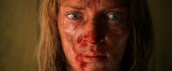 Movie still from “Kill Bill: Vol. 2” (2004), directed by Quentin Tarantino – A person's face covered in blood; Close Up shot, Low angle