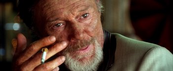 Movie still from “Kill Bill: Vol. 2” (2004), directed by Quentin Tarantino – An older man with a beard and a mustache; Close Up shot, Over the shoulder angle