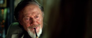 Movie still from “Kill Bill: Vol. 2” (2004), directed by Quentin Tarantino – An old man with a beard and a pipe in his mouth; Close Up shot, Over the shoulder angle