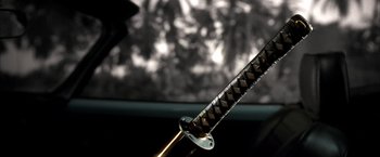 Movie still from “Kill Bill: Vol. 2” (2004), directed by Quentin Tarantino – A samurai sword on a table; Extreme Close Up shot, Low angle