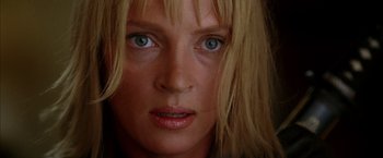 Movie still from “Kill Bill: Vol. 2” (2004), directed by Quentin Tarantino – A woman's face with green eyes; Close Up shot, Low angle