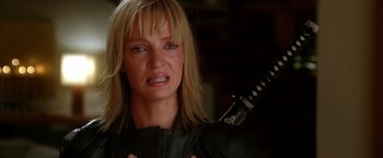 Movie still from “Kill Bill: Vol. 2” (2004), directed by Quentin Tarantino – A person holding a sword; Close Up shot, Low angle