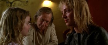 Movie still from “Kill Bill: Vol. 2” (2004), directed by Quentin Tarantino – A man and a woman sitting next to each other in a room; Close Up shot, Over the shoulder angle
