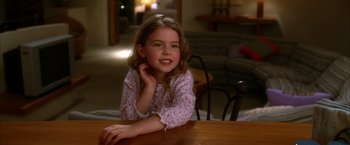 Movie still from “Kill Bill: Vol. 2” (2004), directed by Quentin Tarantino – A young girl sitting at a table in a living room; Close Up shot, High angle